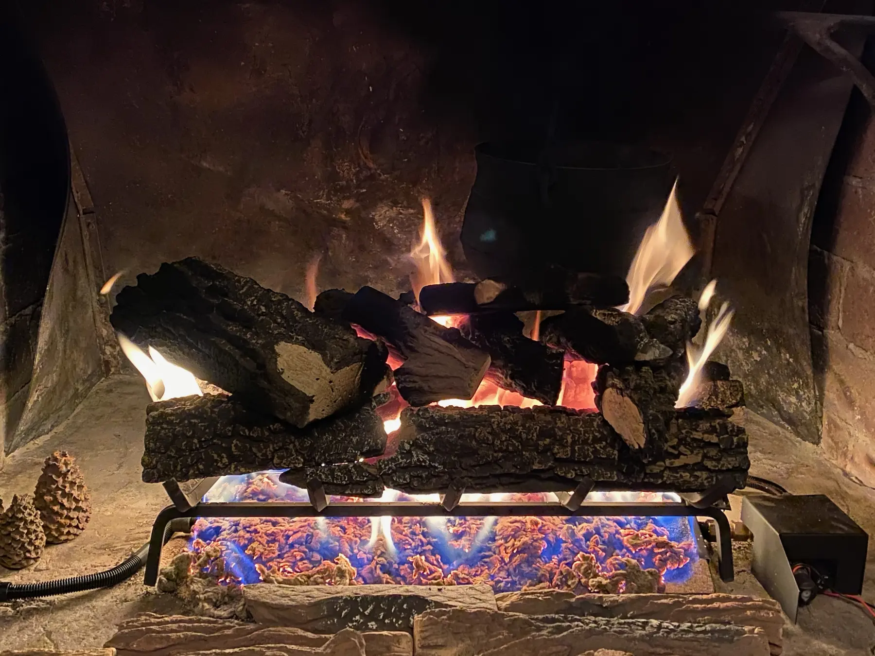 Stone fireplace with a warm fire