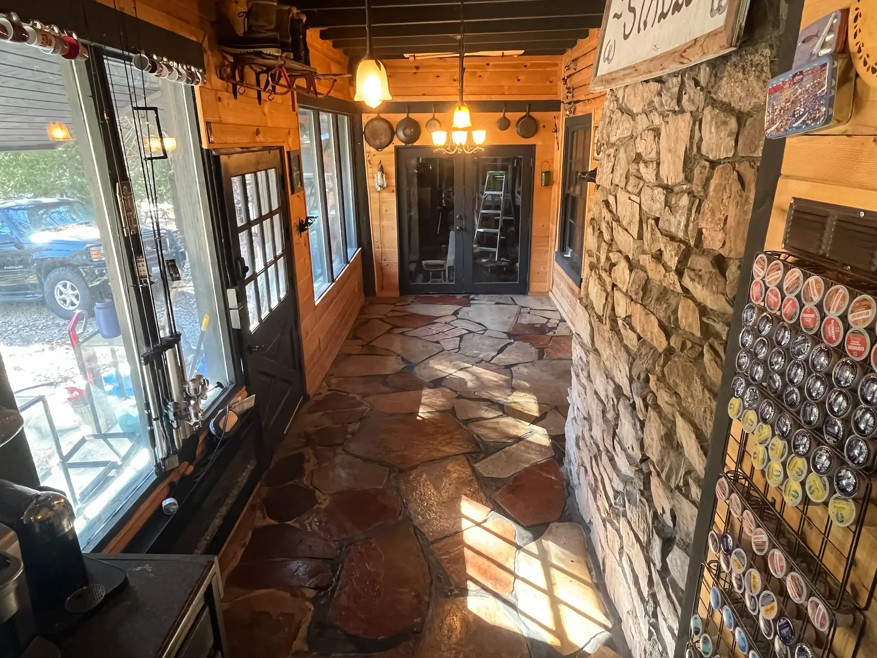 Sunlit stone-floored entry with original wood and stone details